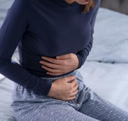 Kobietę boli brzuch ze stresu.