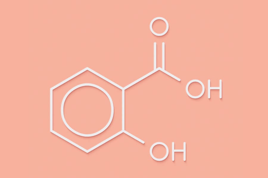 Wzór kwasu salicylowego na różowym tle.