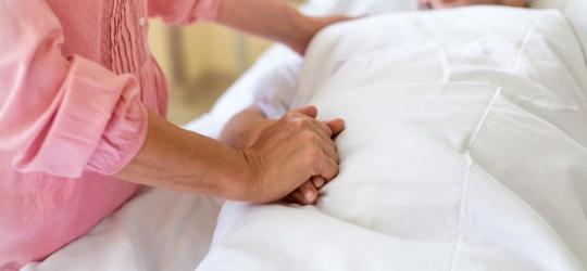 Starsza pacjentka pod opieką bliskiej osoby.