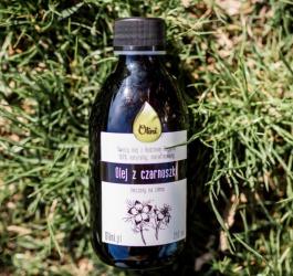 Butelka oleju z czarnuszki marki Olini.