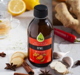 Butelka oxymelu marki Olini.