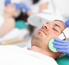 Mężczyzna poddaje się zabiegowi peelingu kawitacyjnego.