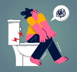 Rysunkowa postać siedzi na toalecie, męczy ją uciążliwa biegunka.