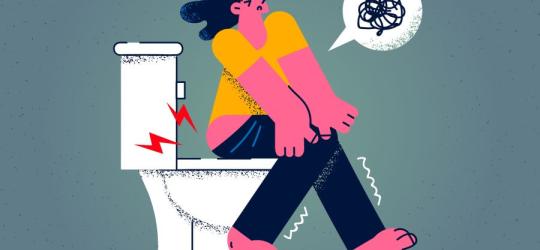 Rysunkowa postać siedzi na toalecie, męczy ją uciążliwa biegunka.