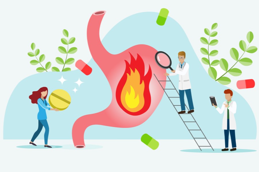 Rysunkowi lekarze podają leki na zgagę.