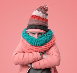 Mężczyzna ubrany jest w wiele warstw ciepłej odzieży. Jest mu zimno z powodu choroby tarczycy.