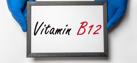 Osoba w rękawiczkach trzyma w dłoniach tabliczkę z napisem