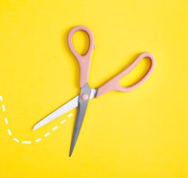Nożyczki na żółtym tle przecinają linię przerywaną.
