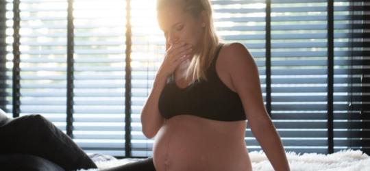 Kobieta w zaawansowanej ciąży zmaga się z objawami zgagi w ciąży.